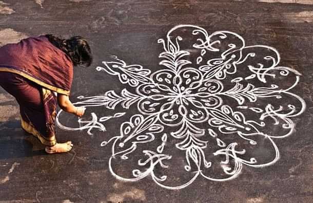 Women creating Kolam in Tamil Nadu